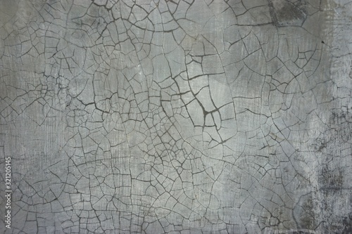 Cracked plaster abstract dirty gray wall horizontal background
