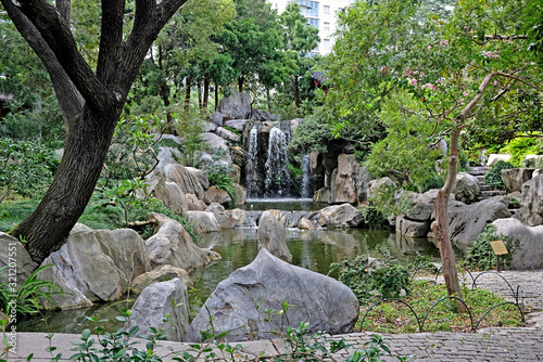 Photography Beautiful Chinese garden and pond surrounding a pagoda contrasted by Sydney city in the background
