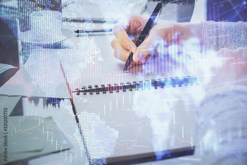 Hand taking notes in notepad. Forex chart holograms in front. Concept of research. Double exposure Hand taking notes in notepad. Forex chart holograms in front. Concept of research. Double exposure
