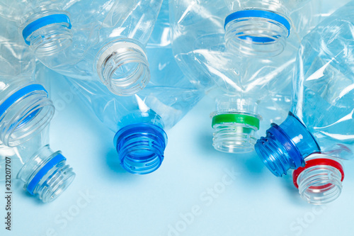 Crumpled plastic bottles on a blue background. Plastic trash