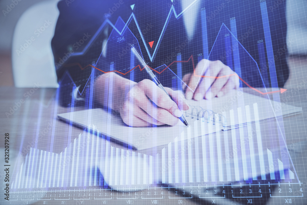 Forex graph on hand taking notes background. Concept of research. Multi exposure Forex graph on hand taking notes background. Concept of research. Multi exposure