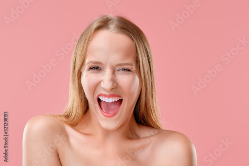 Beautiful girl screaming loud with mouth wide open