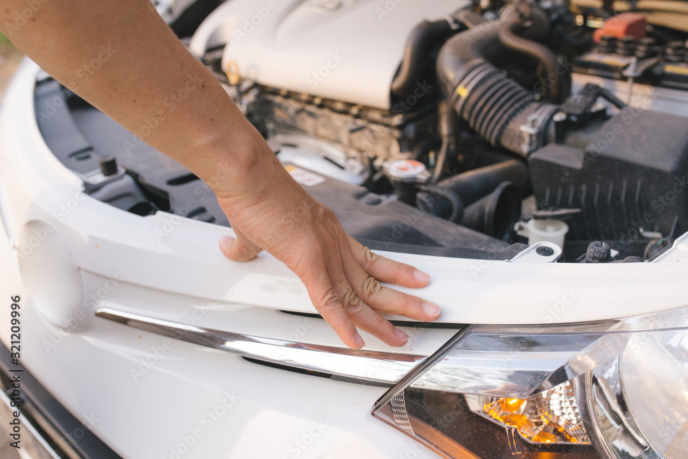 young stressed man having trouble with his broken car looking in frustration at failed engine young stressed man having trouble with his broken car looking in frustration at failed engine