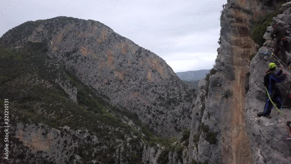 Three alpinists are hanging on a side of a mountain, aerial footage, 4k Three alpinists are hanging on a side of a mountain, aerial footage, 4k