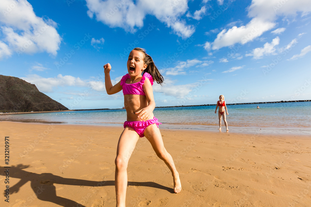 Adorable happy smiling little girl on beach vacation Adorable happy smiling little girl on beach vacation