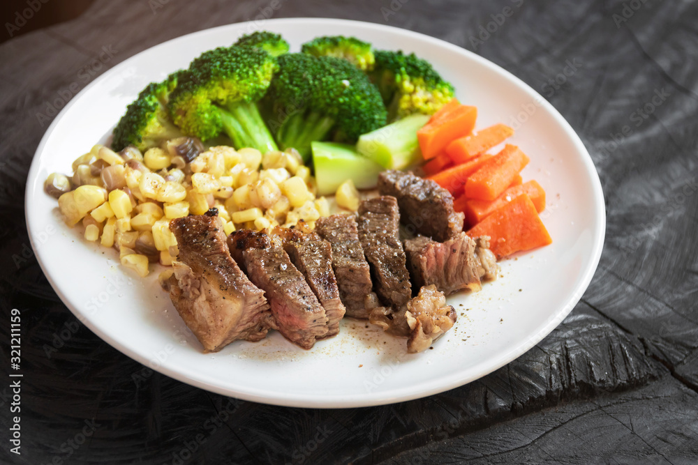 Grilled beef slice with sweet corn, broccoli and carrot on white plate. Easy and delicious meal at home. Grilled beef slice with sweet corn, broccoli and carrot on white plate. Easy and delicious meal at home.