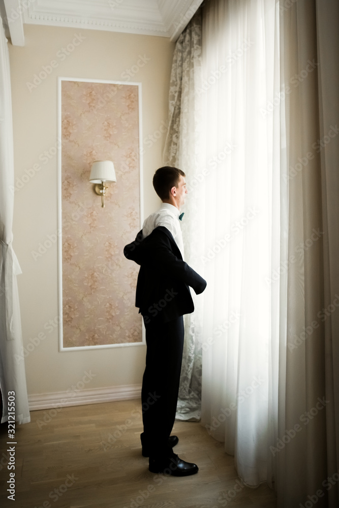 Fototapeta premium Beautiful man, groom posing and preparing for wedding
