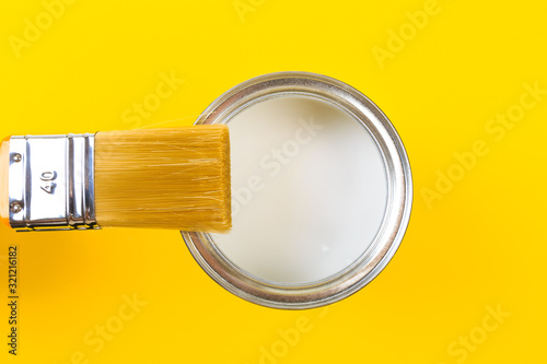 White Paint Can with Brush Top View On Yellow Background. - Image