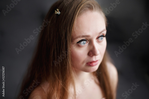 Close-up portrait of natural beautiful thoughtful woman with anxiety facial expression