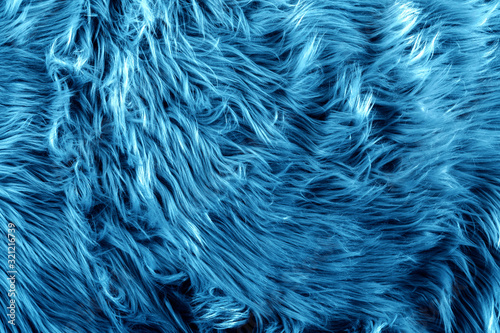 Blue fur for background or texture. 2020 Classic Blue pantone. Fuzzy blue fur plaid. Shaggy blanket background. Fluffy fake textile fur. Flat lay, top view, copy space