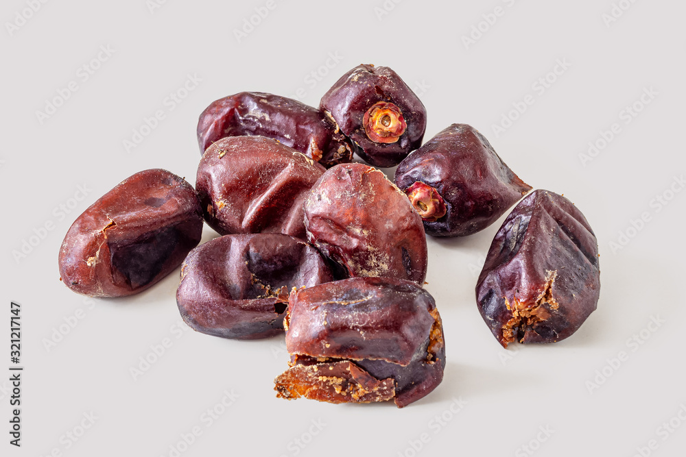 Dried dates on a light grey background
