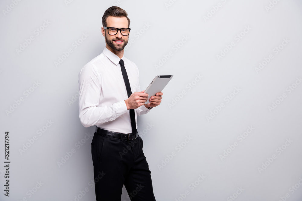 Portrait of confident cool leader man boss success freelancer use tablet enjoy decide start-up decisions wear black pants formalwear clothes isolated over grey color background Portrait of confident cool leader man boss success freelancer use tablet enjoy decide start-up decisions wear black pants formalwear clothes isolated over grey color background