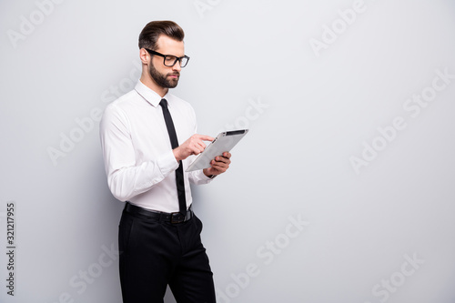 Portrait of concentrated executive lawyer use tablet search start-up news workshop read enterprise documents wear white black pants trousers isolated over grey color background