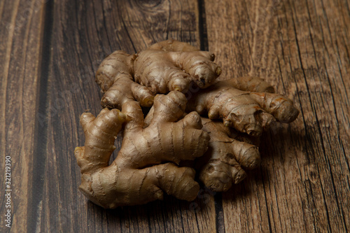 Ginger.Ginger root on a wooden background. Vegetarianism.