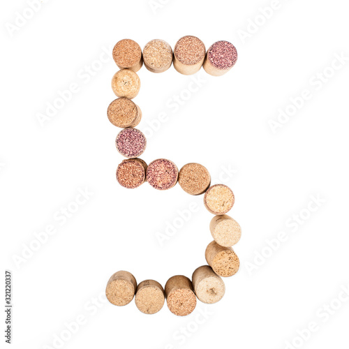 The number 5 is made from wine corks, close-up. Isolated on white background