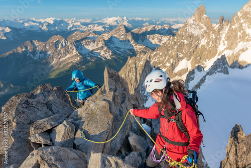 Vászonkép Adventure seeking mountain climbers high up in the mountains