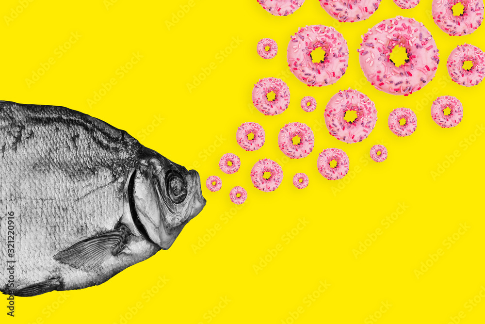 Fototapeta Concept fish and donuts on a colored background. Modern art collage.