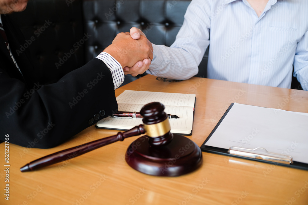 Legal counsel presents to the client a signed contract with gavel and legal law. justice and lawyer concept. Legal counsel presents to the client a signed contract with gavel and legal law. justice and lawyer concept.