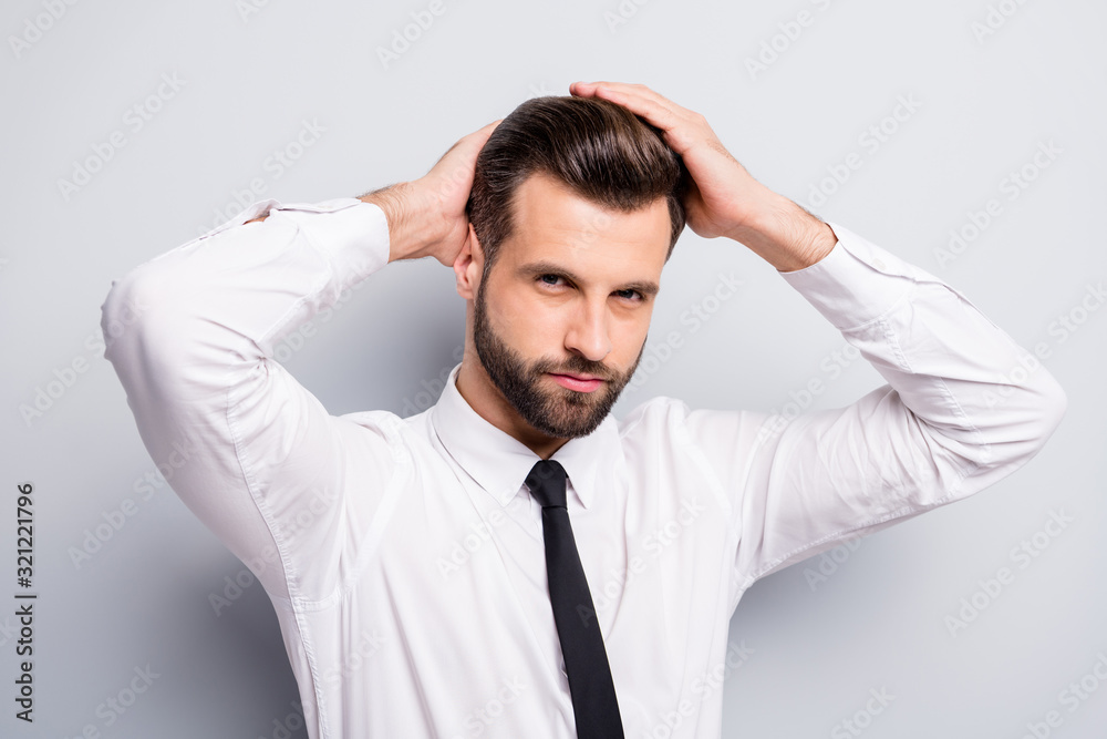Closeup photo of young handsome serious business man touch perfect groomed hairstyle after salon styling macho guy wear white office shirt tie isolated grey color background Closeup photo of young handsome serious business man touch perfect groomed hairstyle after salon styling macho guy wear white office shirt tie isolated grey color background
