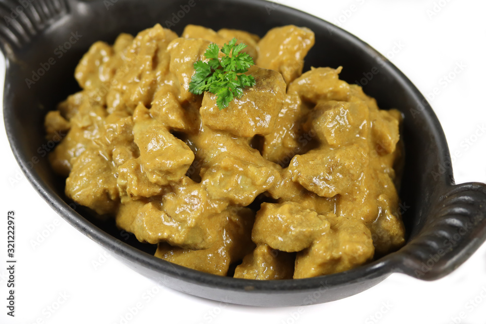 meat cooked in curry and coconut milk