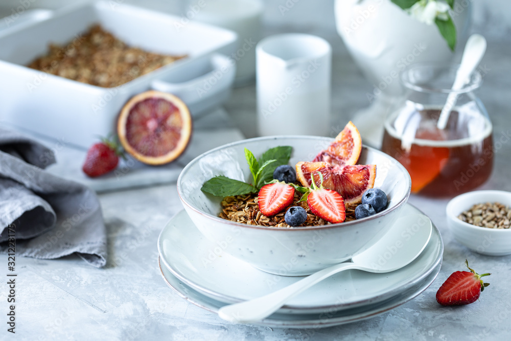 Healthy breakfast with granola, yogurt, fruits, berries on a white plate in white plate. Healthy breakfast with granola, yogurt, fruits, berries on a white plate in white plate.