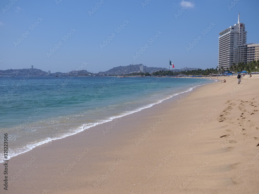 Sandy beach with skyscrapers in ACAPULCO city in Mexico at bay of Pacific Ocean