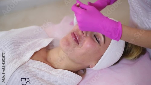 Female cosmetician using liquid nitrogen.