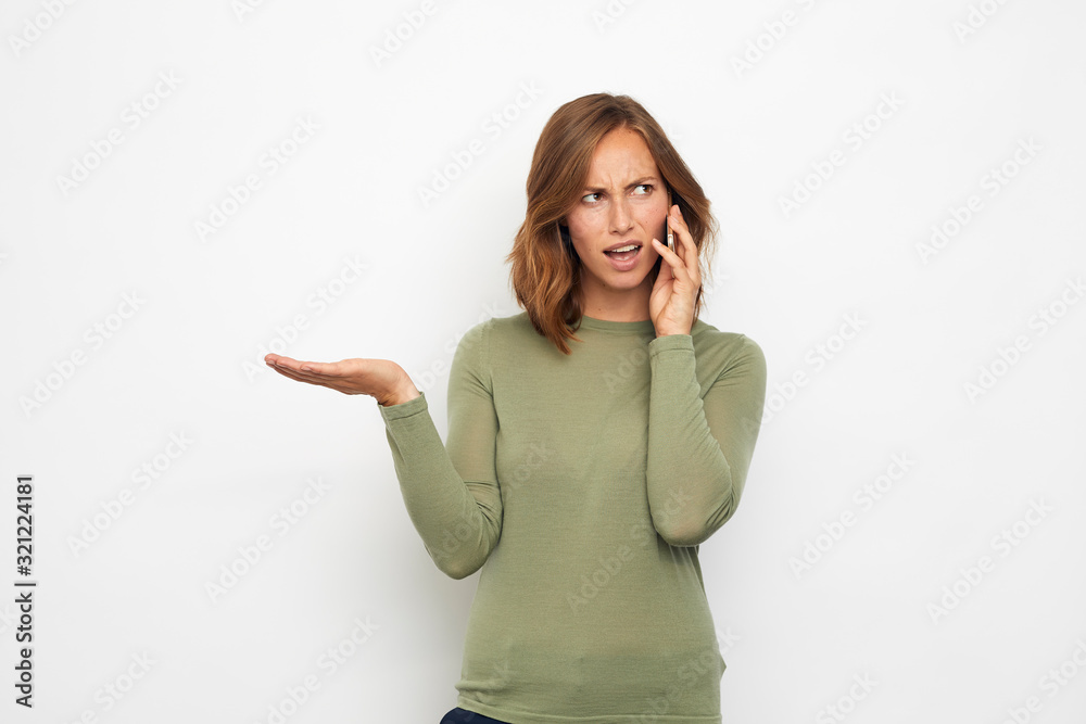 portrait of young woman with phone looking angry portrait of young woman with phone looking angry