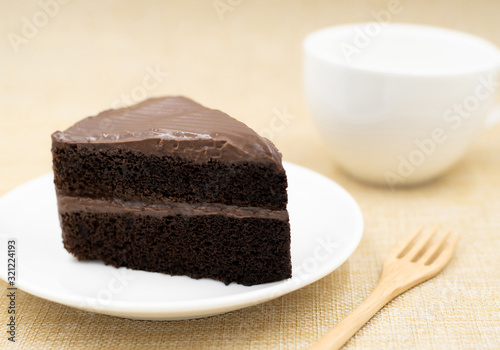 Chocolate cake with a white coffee cup.