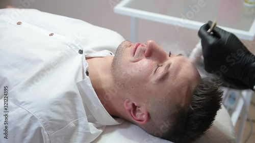 Therapy with liquid nitrogen for the face of a man.