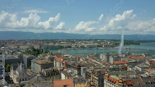 flight over sunny geneva central cityscape lakeside fountain rooftop aerial panorama 4k switzerland