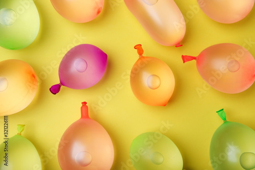 backdrop of multicolor water balloons on yellow background