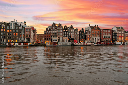 Amsterdam traditional houses along the Amstel in Amsterdam the Netherlands at sunset
