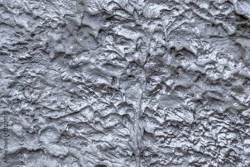Abstract silver color painted on grunge rough surface of stucco concrete wall. Good for  texture background and wallpaper © Garmon