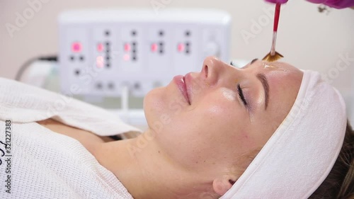 Beautiful woman with facial mask at beauty salon