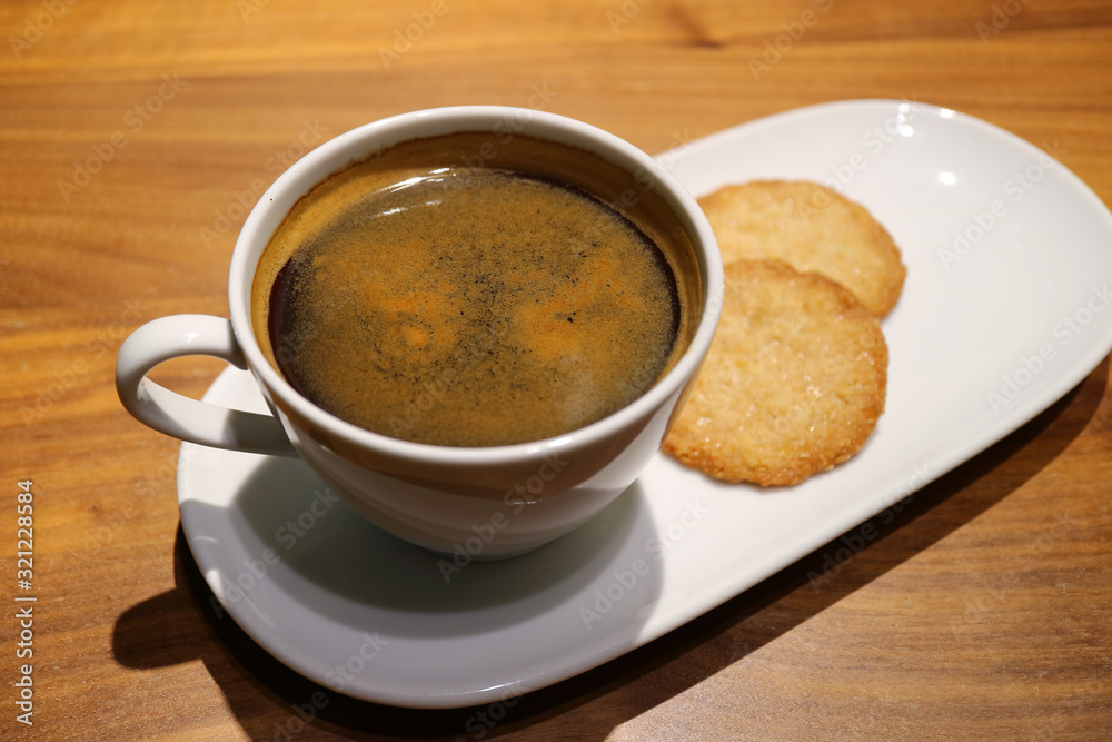 Cup of Black Coffee with Some Cookies Served on Wooden Table