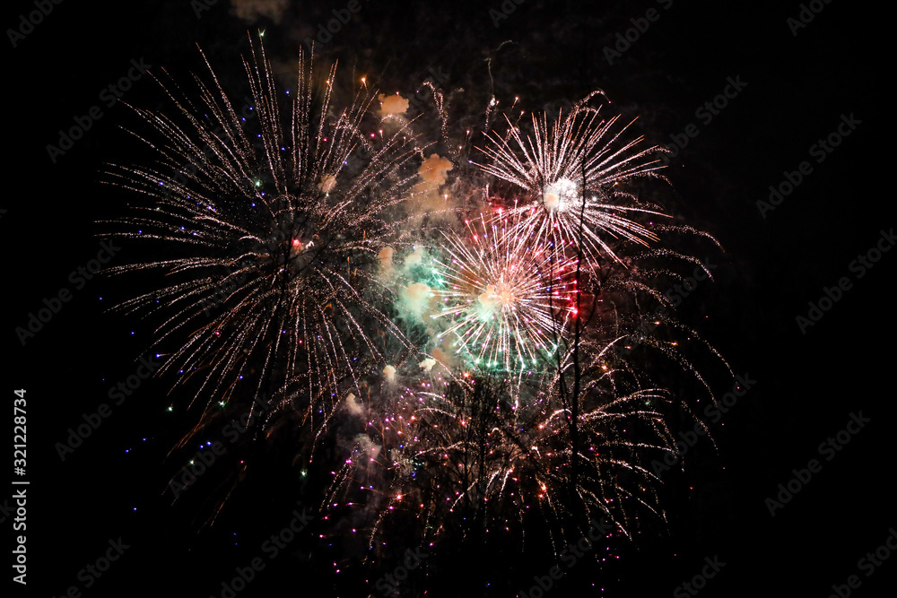 Beautiful new years firework celebration in black evening sky. Beautiful new years firework celebration in black evening sky.