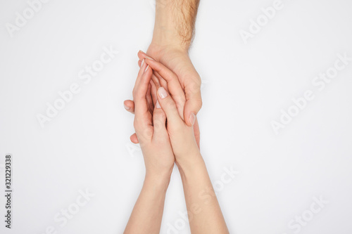 top view of couple holding hands isolated on white