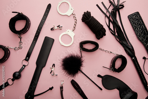 top view of black sex toys on pink background