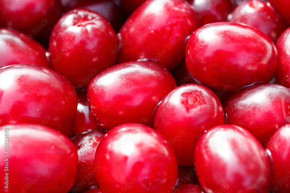 Fresh ripe red cornelian cherries as a background Fresh ripe red cornelian cherries as a background