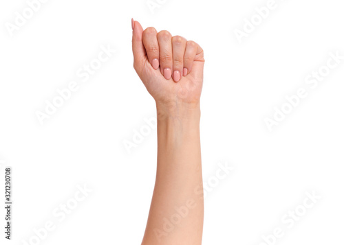 Female hand with fingers folded into fist, isolated on white background. Beautiful hand of woman with copy space.