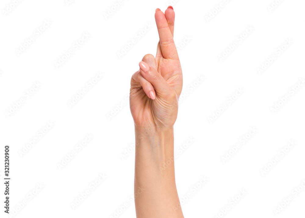 Female hand showing crossing fingers gesture, isolated on white background. Beautiful hand of woman with copy space. Female hand showing crossing fingers gesture, isolated on white background. Beautiful hand of woman with copy space.