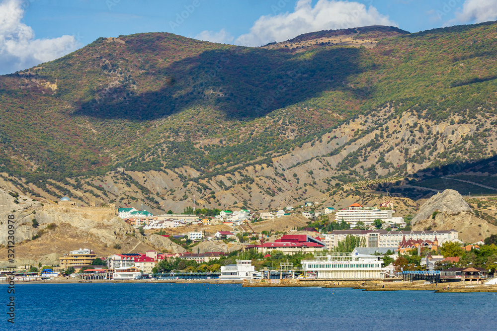 Panorama of resort town from Cape Alchak. City is located in valley between mountains. Velvet season in one of pearls of southern coast of Crimea. Sudak, Crimea, Russia , October, 2019.