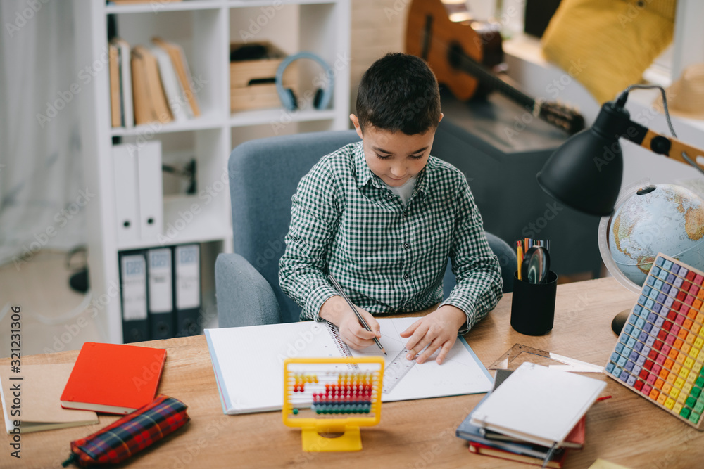 Cute little boy doing homework. Child learning foe school. Cute little boy doing homework. Child learning foe school.