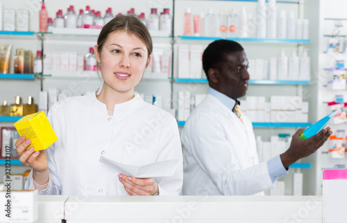 woman pharmacist dispensing prescription medicines
