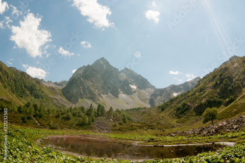 Natural landscape photo of small mountain lake in North Caucasus at Fisht and Oshten mountains photo