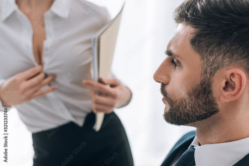 Stockfoto selective focus of businessman looking at sexy secretary with big  breast in office | Adobe Stock