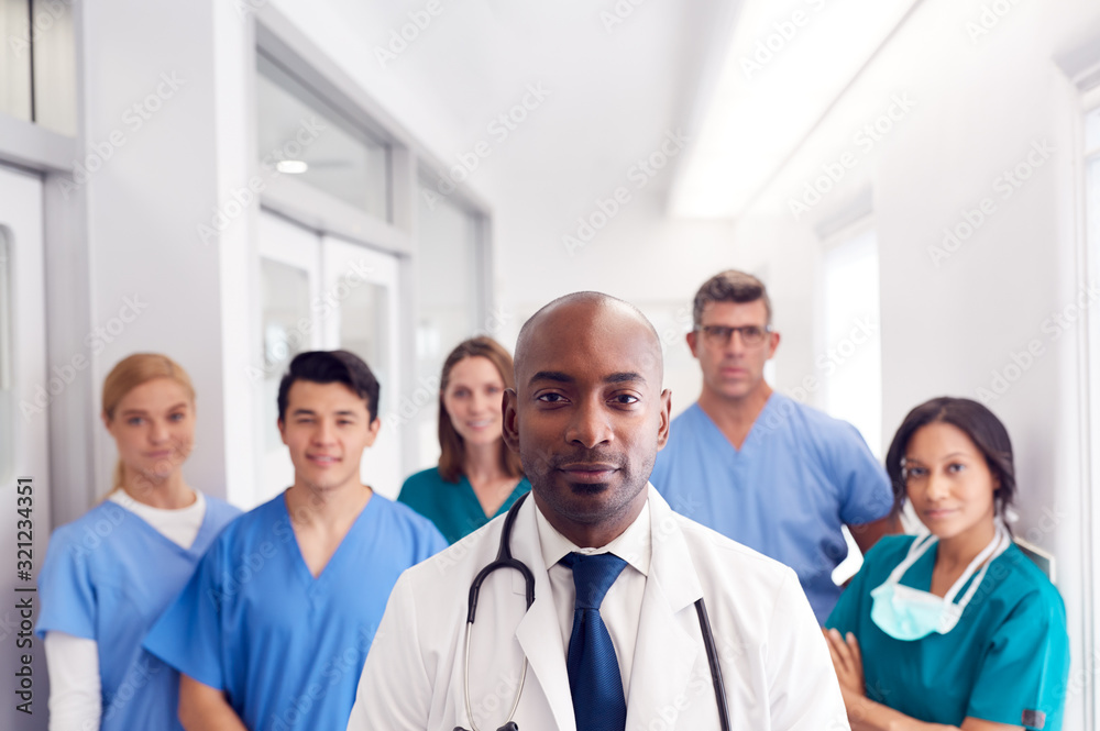 Portrait Of Multi-Cultural Medical Team Standing In Hospital Corridor Portrait Of Multi-Cultural Medical Team Standing In Hospital Corridor