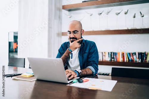 Busy employee watching computer at workplace