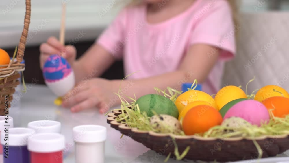 Happy easter. Little girl painting Easter eggs. Happy family children preparing for Easter. Cute little child girl wearing bunny ears on Easter day Close up Happy easter. Little girl painting Easter eggs. Happy family children preparing for Easter. Cute little child girl wearing bunny ears on Easter day Close up